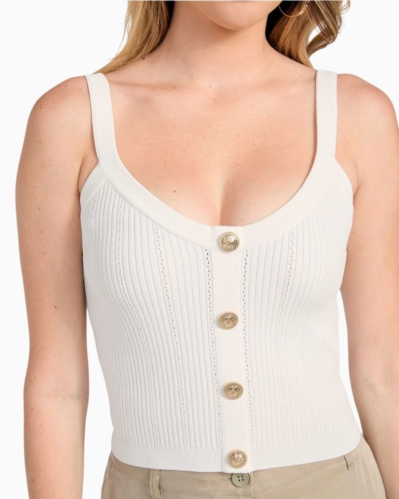 Close up of GUESS white knit crop tank with scoop neck and tie-back detail