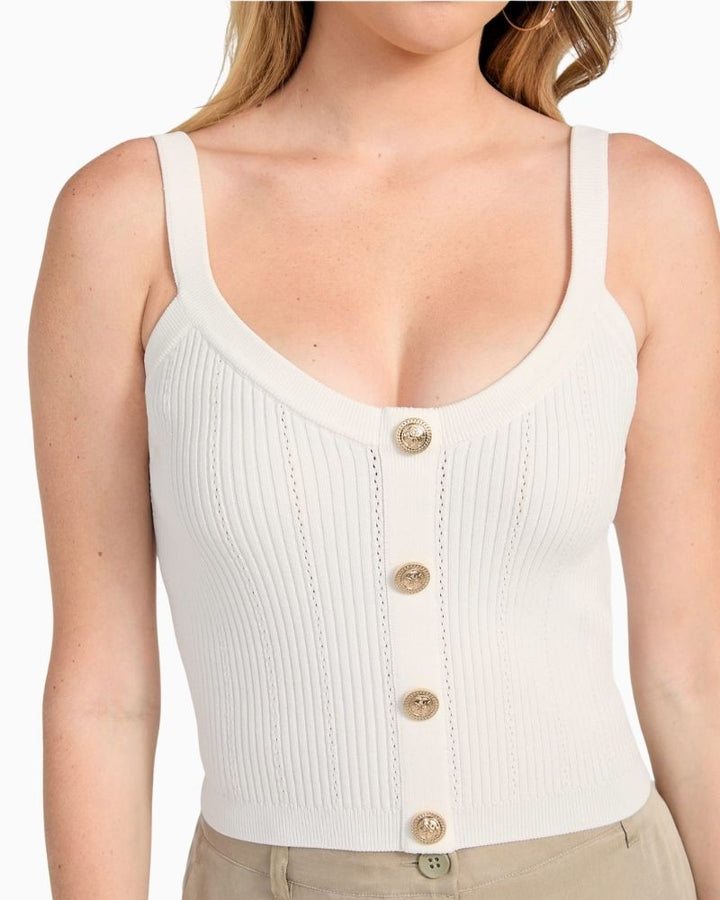 Close up of GUESS white knit crop tank with scoop neck and tie-back detail