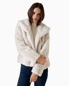 Front view of soft faux fur coat with hook closure and regular fit