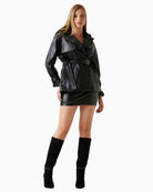 Front view of GUESS faux leather trench coat in black with sash belt and snap closure