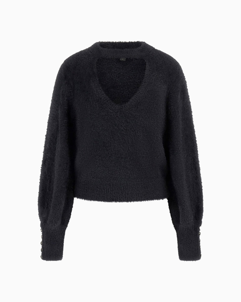 Front view of cropped knit jumper with dropped shoulders and buttoned cuffs