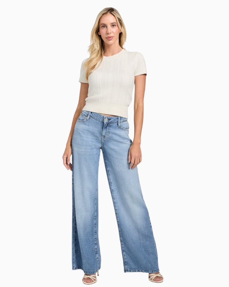 Eco-friendly short sleeve knit top styled with trousers for smart-casual look
