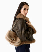Guess handbag styled with winter coat for a cosy seasonal look