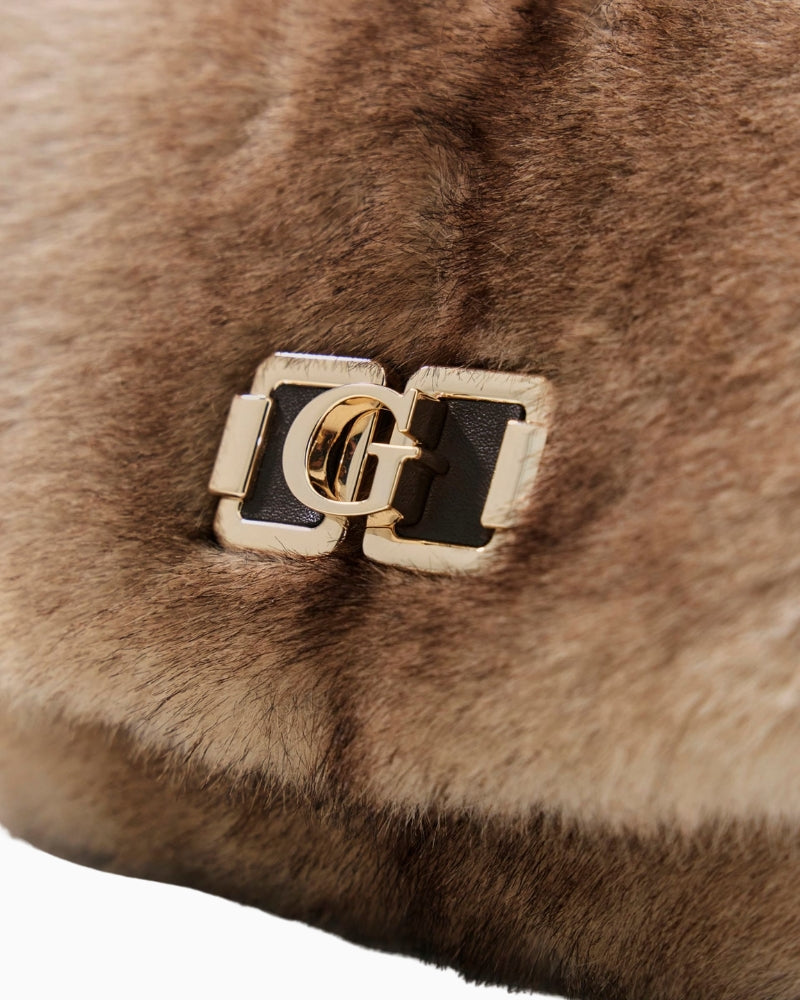 Close-up of snap button closure and detachable Guess charm detail
