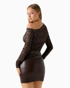 Back view showing one‑shoulder neckline and long sleeve detail