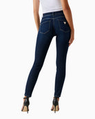 Back of Guess skinny jeans showing shaping fit and dark denim tone