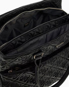 Interior of Adelasia tote with logo lining and multiple zip pockets
