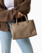 Guess Anise Handbag taupe carried by hand showing structured shape