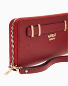 Close-up of detachable zipper pull and pale gold hardware on Guess wallet