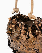 Close-up of rhinestone handle and pale gold hardware on Guess handbag