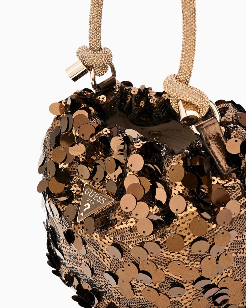 Close-up of rhinestone handle and pale gold hardware on Guess handbag