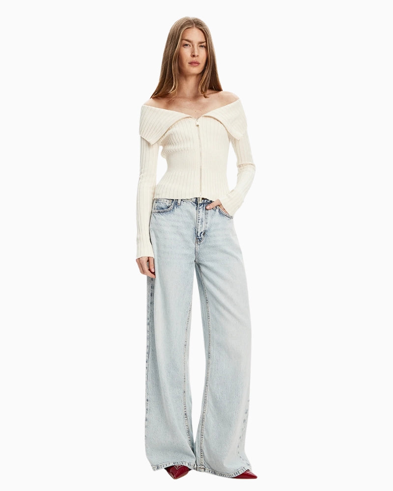 Model wearing Guess cream cardigan with full zip, styled casually with denim jeans