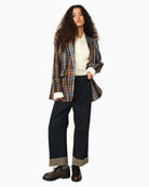Front view of longline women’s blazer with flap pockets and single button