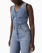 Woman wearing Levi’s denim wide-leg jumpsuit, full outfit model view – Áines Boutique