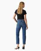 Back view of Levi’s Wedgie jeans showing snug fit through hip and vintage-style distressing