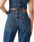 Woman wearing Levi’s Ribcage wide leg jeans dark wash, back view – Áines Boutique