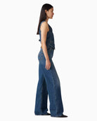 Woman wearing Levi’s Ribcage wide leg jeans dark wash, side view – Áines Boutique