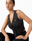 Close-up of corset bone detailing and button fastening on denim corset