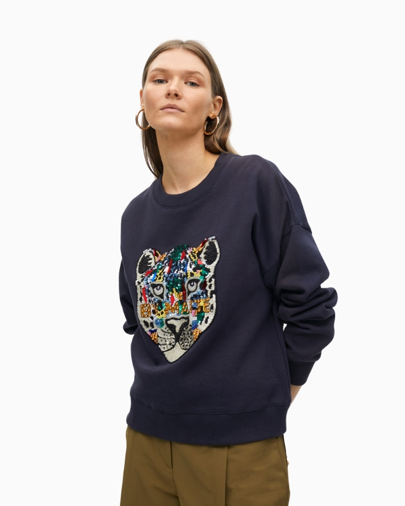 Front view of long-sleeve sweatshirt with striking motif and embellishment