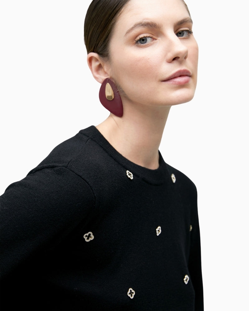 Close-up of jewel detail on soft black knit jumper