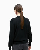 Back of Black merino blend knit sweater by Lola Casademunt with jewel embellishment