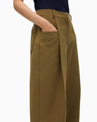 Close-up of metallic logo at belt loop on Lola Casademunt trousers