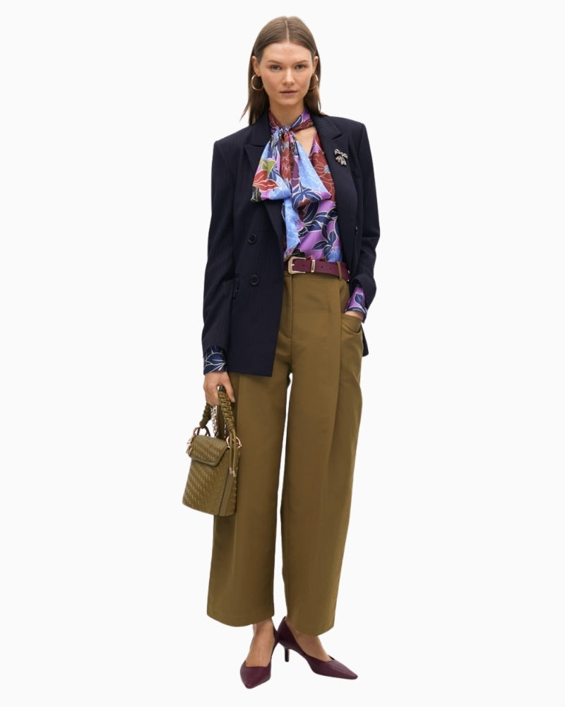 Lola Casademunt blouse styled tucked into trousers with soft bow neckline
