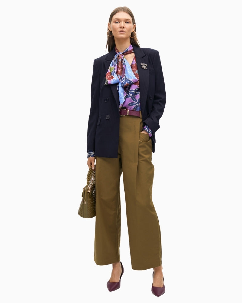 Lola Casademunt blouse styled tucked into trousers with soft bow neckline