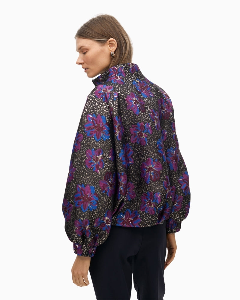Side view showing raised collar and zip closure on bomber