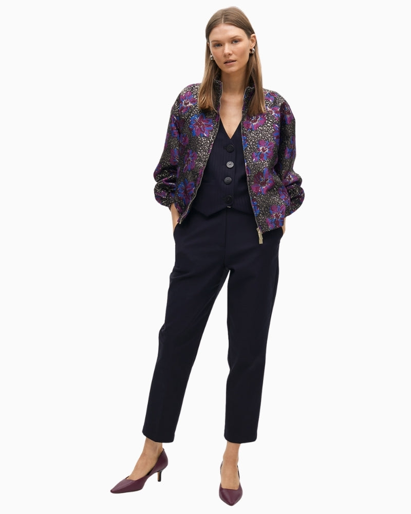 Lola Casademunt floral bomber styled over a black dress for evening wear