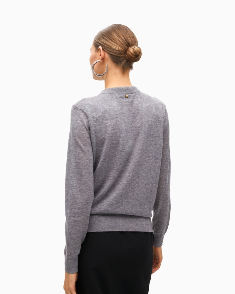 Back view of knit sweater showing button closure and smooth finish