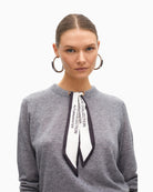 Close up of Soft long-sleeve knit top in wool blend with attached scarf