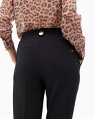 Close-up of decorative gold buttons on waistband