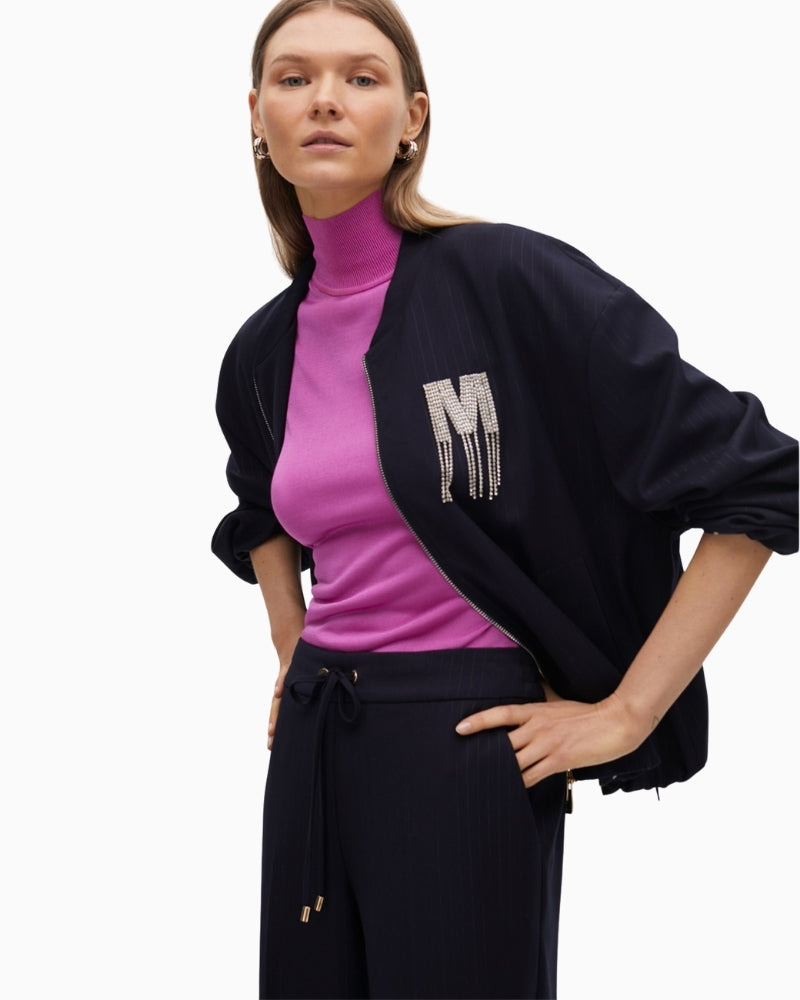 Side view showing puff sleeve and elastic cuff on bomber jacket