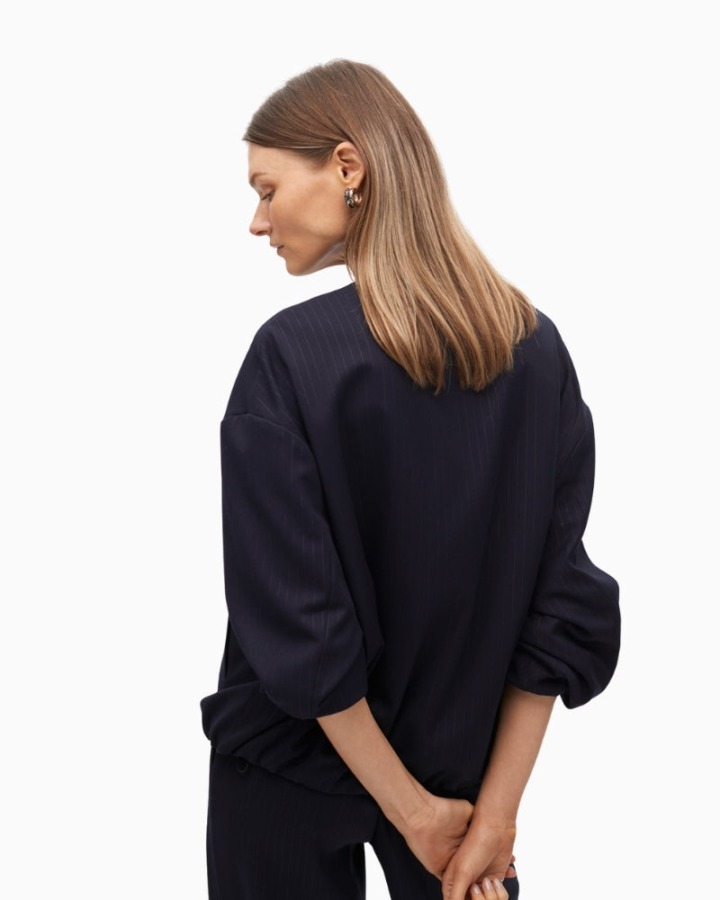 Backview showing puff sleeve and elastic cuff on bomber jacket
