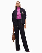 Pinstripe bomber jacket styled with tailored trousers for a chic day-to-evening look