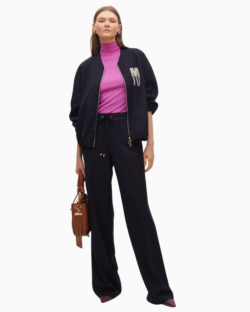 Pinstripe bomber jacket styled with tailored trousers for a chic day-to-evening look