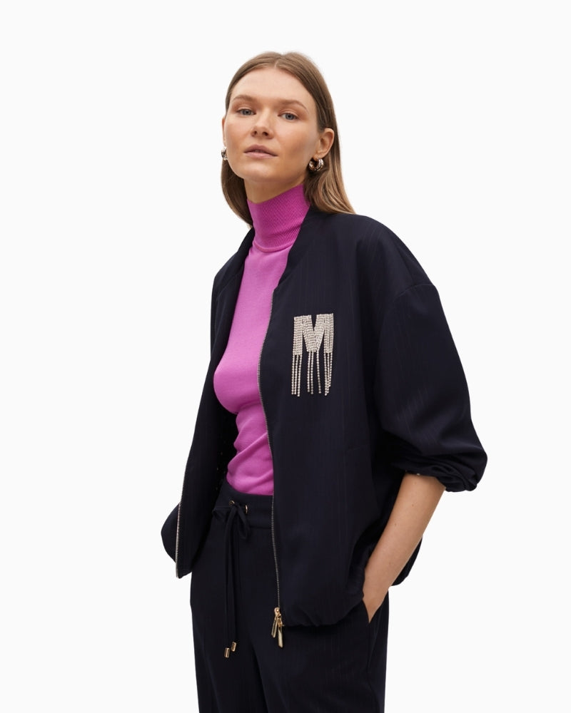 Side view showing puff sleeve and elastic cuff on bomber jacket