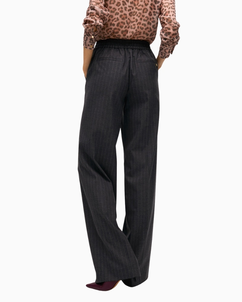 Back view showing stud embellishments and relaxed denim fit