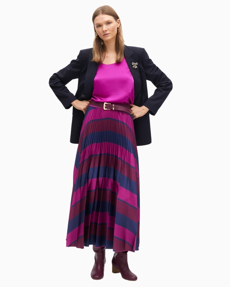 Satin top styled under blazer with tailored trousers for an elegant look