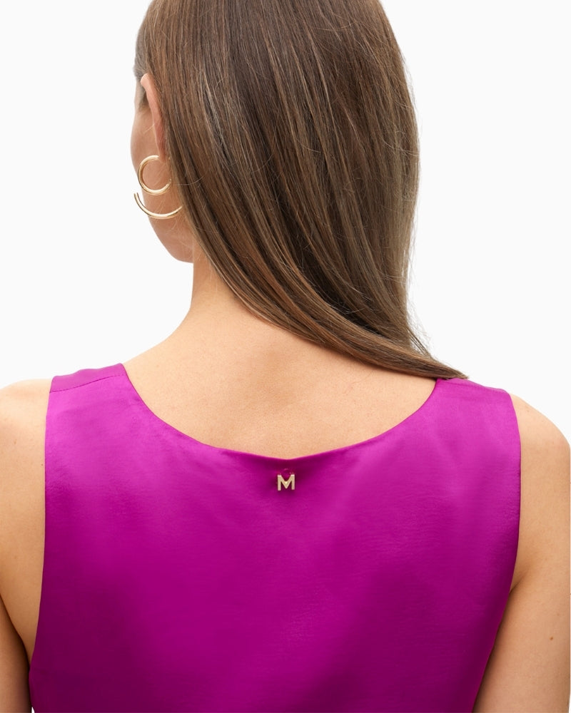 Close-up of silky satin fabric and metal logo at back