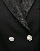 Close up of Cropped structured jacket with bold lapel and tailored shape