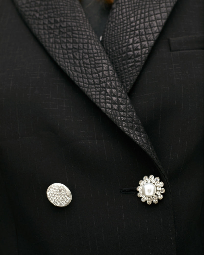 Close up of Cropped structured jacket with bold lapel and tailored shape