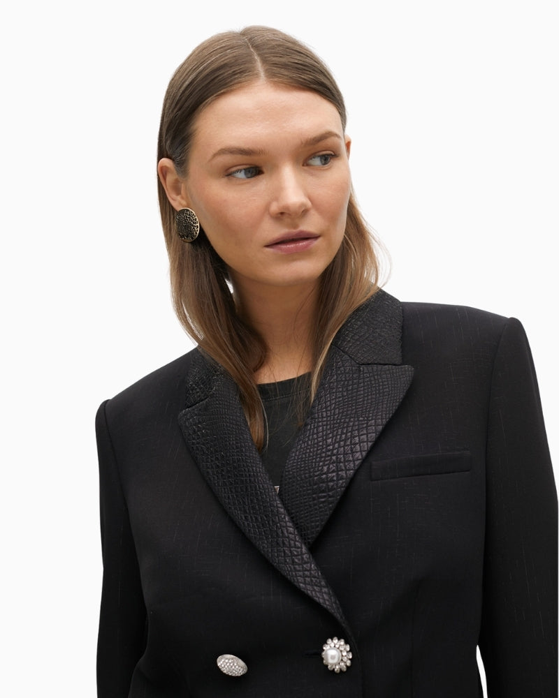 Close up of Cropped structured jacket with bold lapel and tailored shape