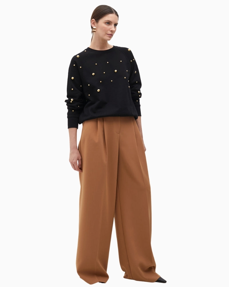 Front view of round neck sweatshirt with evenly spaced golden studs