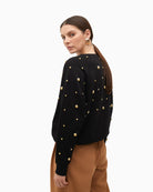 Side of Lola Casademunt cotton sweatshirt with gold stud details and ribbed finish