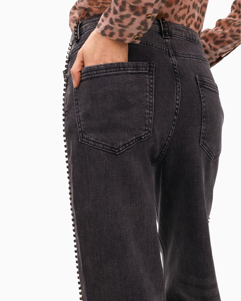 Close-up of high waist and metallic button closure on stretch denim
