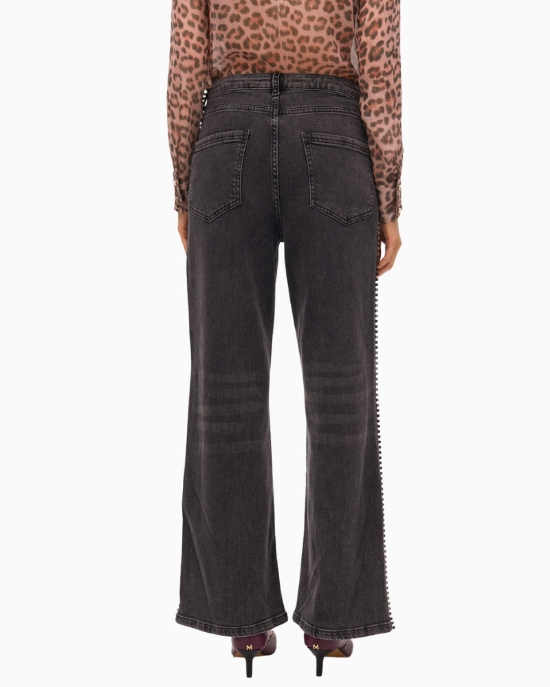Back view showing stud embellishments and relaxed denim fit