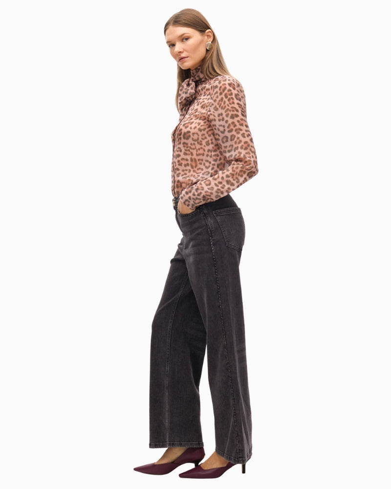 Side view showing stud embellishments and relaxed denim fit