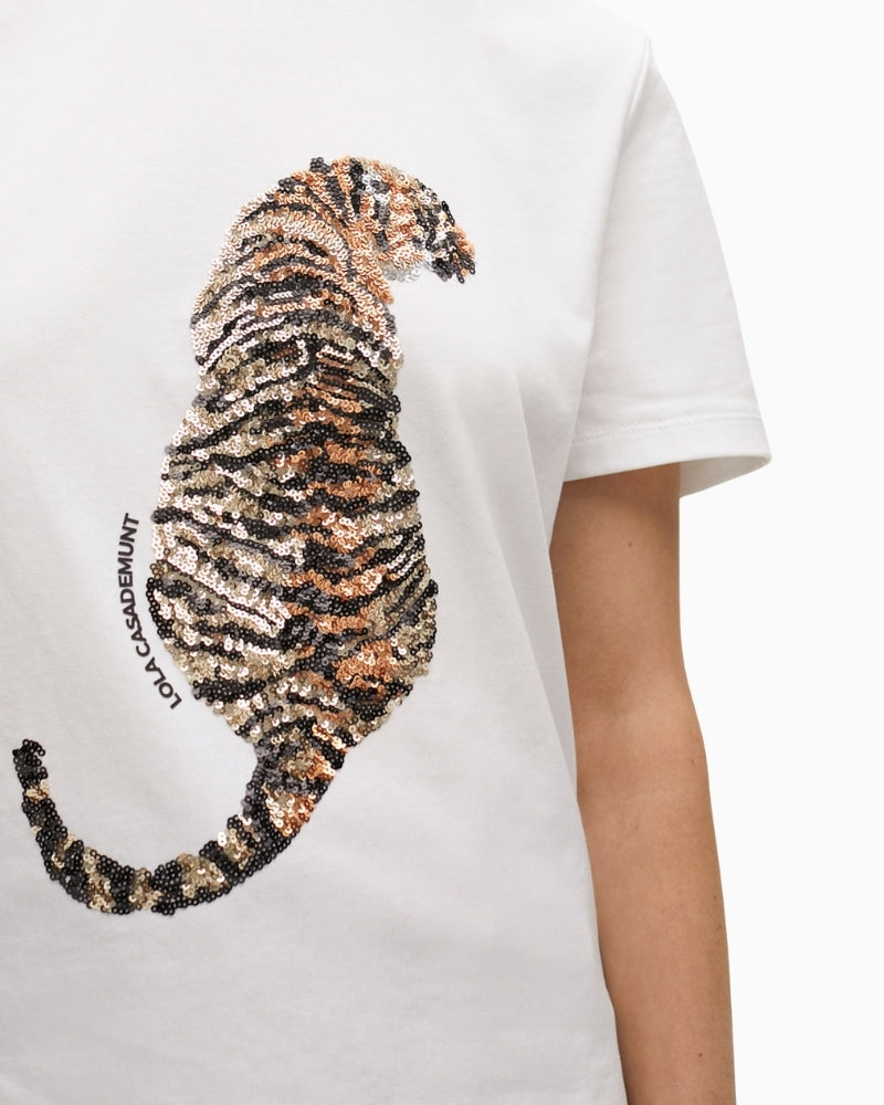 Close-up of sparkling tiger design on white cotton fabric